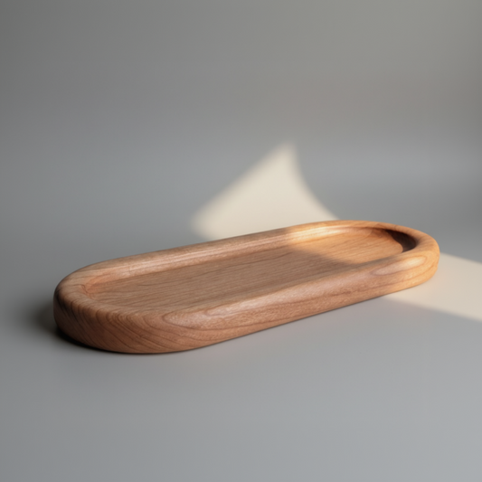 Wooden tray made of cherry wood on a gray surface with soft lighting