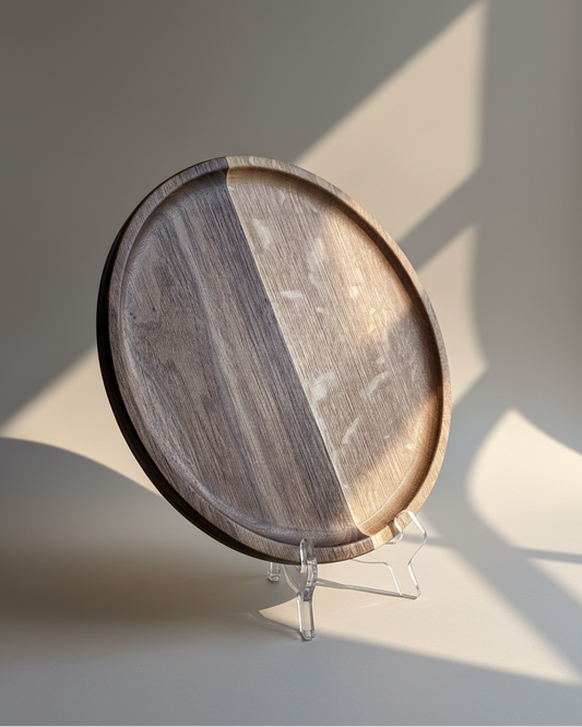 Wooden round tray on a stand with a soft shadow on a light background