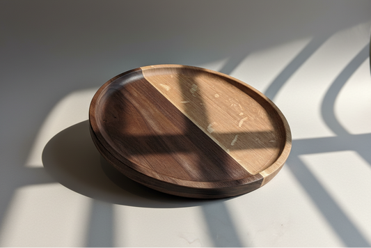 Wooden plate with two different wood finishes on a light surface