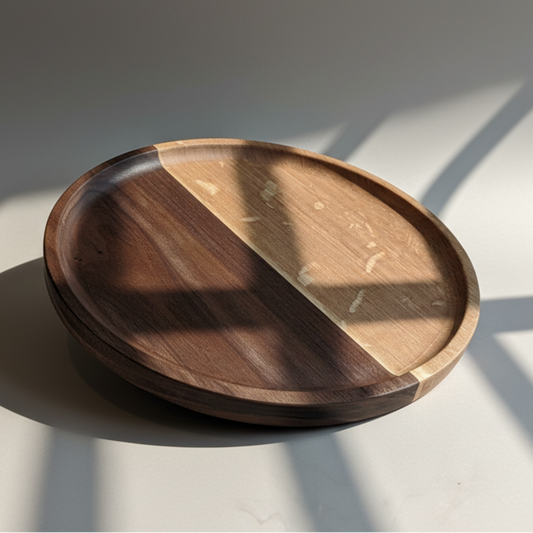 Wooden plate with two different wood finishes on a light surface