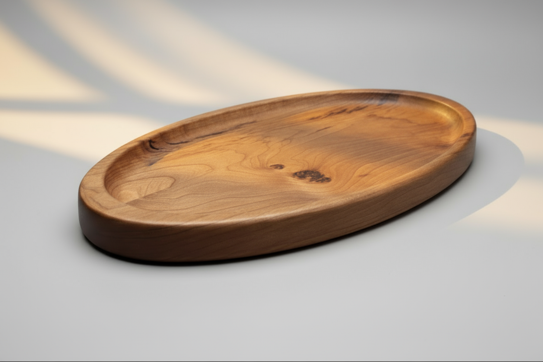 Wooden oval tray on a gray background