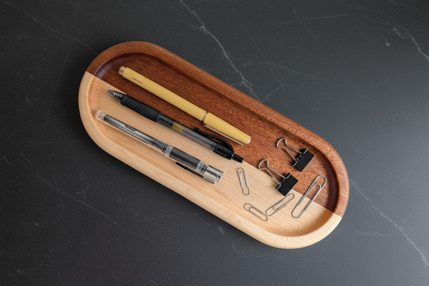 Wooden desk organizer with stationery items on a dark surface