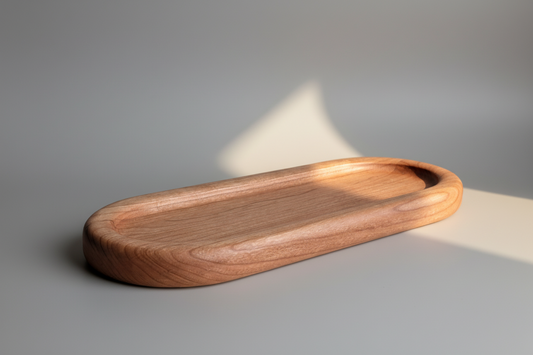 Wooden tray made of cherry wood on a gray surface with soft lighting