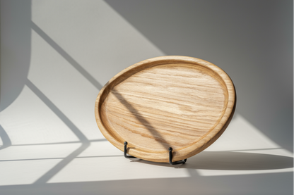 wooden tray in direct sunlight with a light gray background
