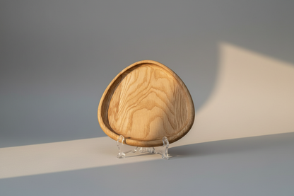 Wooden bowl on a stand with a gray background
